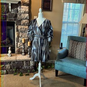 This dress is above the knees. Ruched sleeves. Navy blue and is 100% polyester.